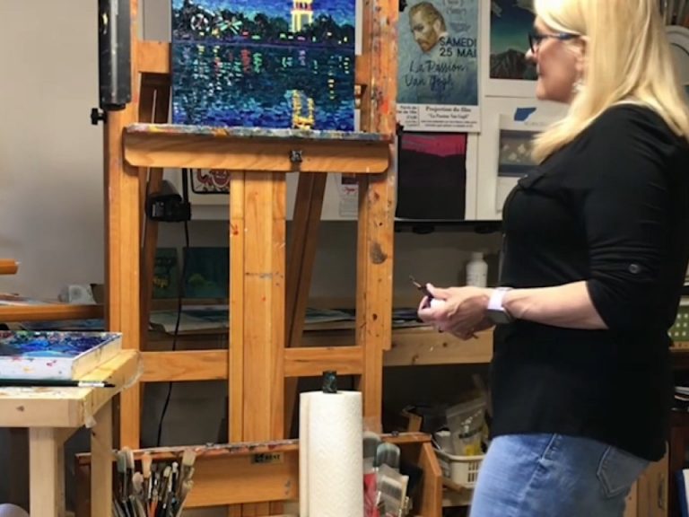 Artist Dena Peterson painting in studio