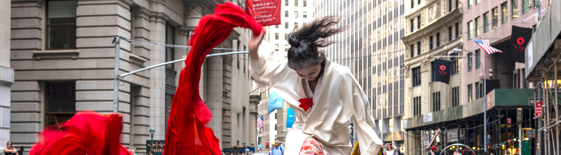 Eiko Otake dancing with red fabric on Wall Street