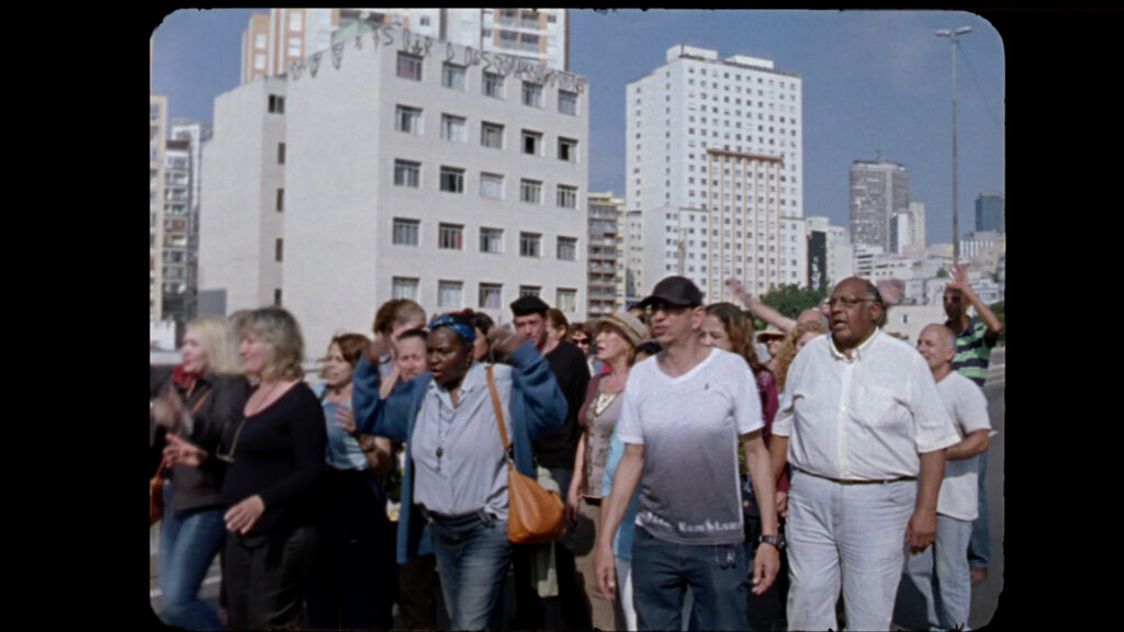 Film still - diverse group if people walking