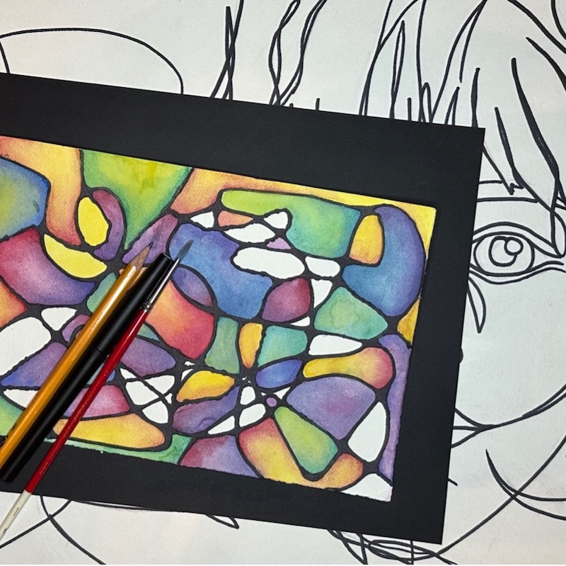 an art piece made with swirling with different colors filling in the shapes made by their intersections