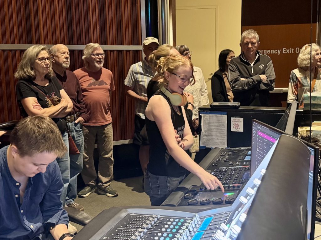 members look at the soundboard and listen to a presentation