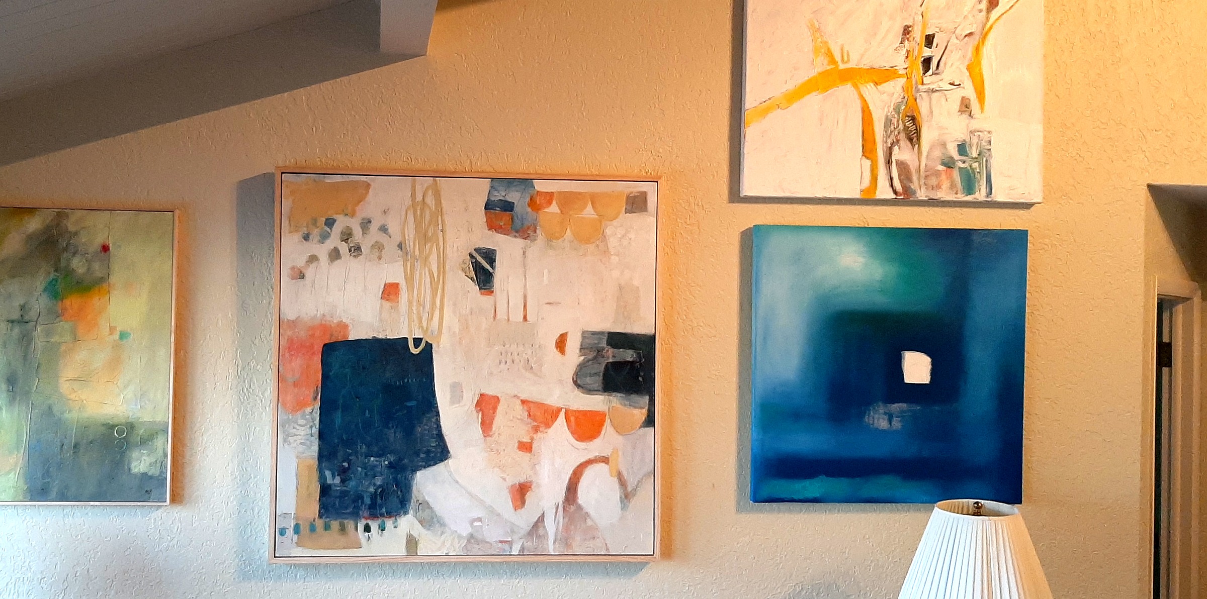 Several pieces of contemporary art hang in a hallway in the Campbell-Wild home.
