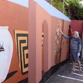 Colorado muralist Emanuel Martinez repainting Arte Mestiza at the Fine Arts Center parking lot